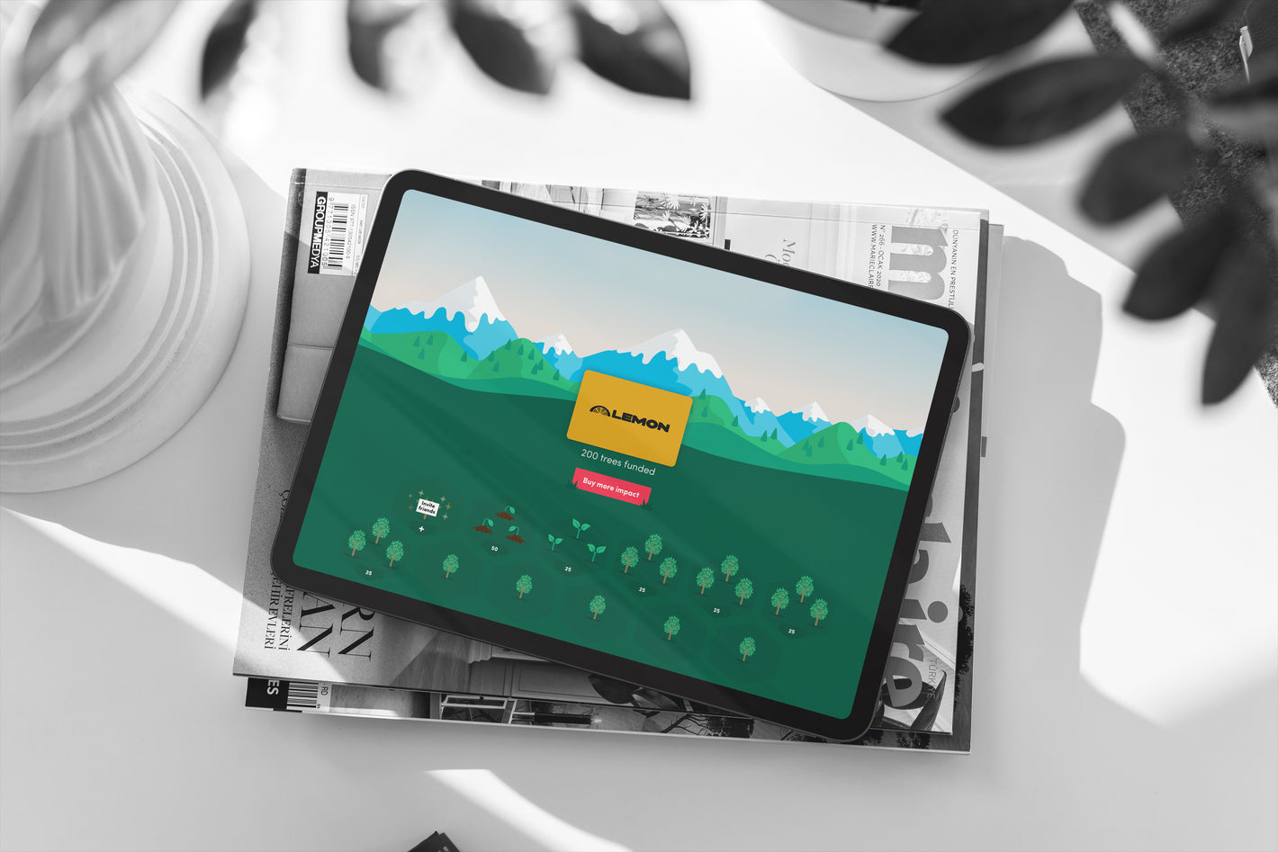 A iPad displaying a tree planting initiative by Lemon in partnership with Ecologi.