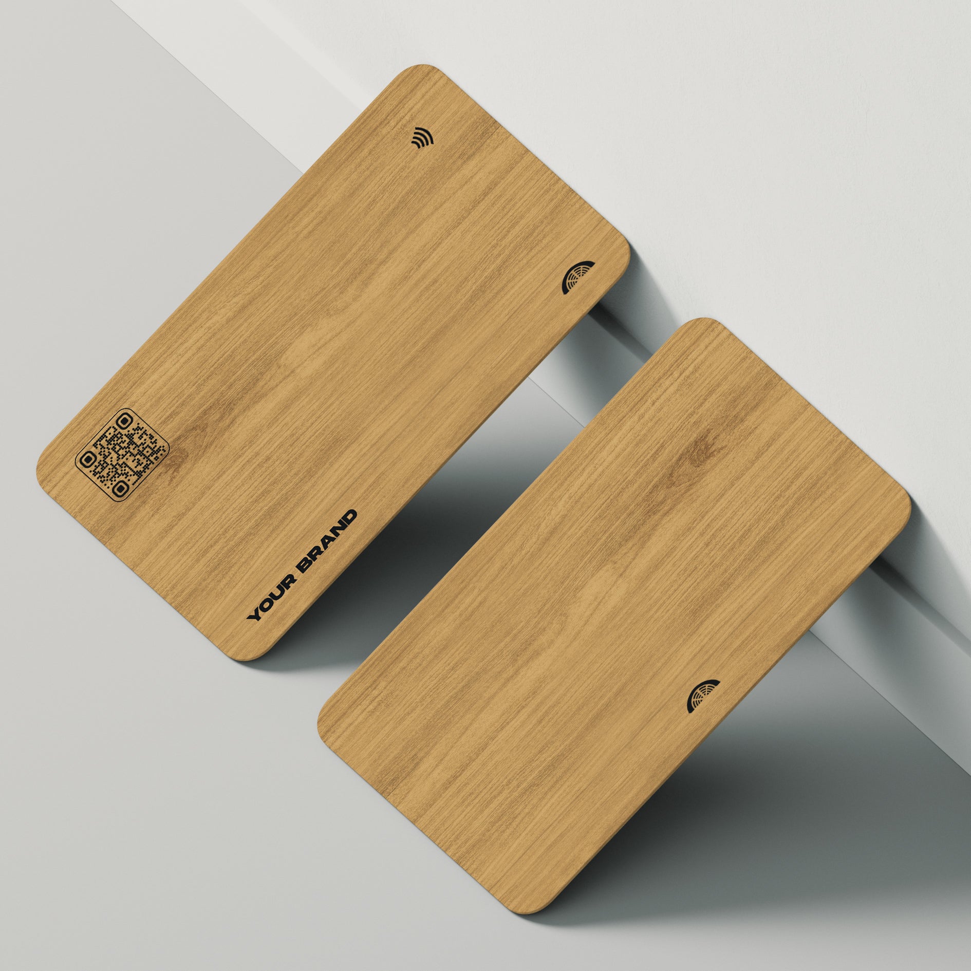 Two NFC-enabled business cards stacked atop one another, made of sustainable bamboo